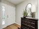 Inviting foyer with a decorative mirror, stylish cabinet, and a bright, welcoming entrance door at 9324 W Point Pl, Indianapolis, IN 46268
