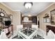 Eat-in kitchen featuring a cooktop, neutral walls, tile floors and a glass dining table at 9324 W Point Pl, Indianapolis, IN 46268