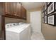 Functional laundry room with ample storage, modern appliances, and tiled floors at 9324 W Point Pl, Indianapolis, IN 46268