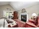 Cozy living room with a fireplace, comfortable seating, and natural light from the sliding glass doors at 9324 W Point Pl, Indianapolis, IN 46268