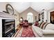 Cozy living room features fireplace, built-in shelving, and a large window for natural light at 9324 W Point Pl, Indianapolis, IN 46268