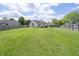 Expansive backyard showcasing a lush lawn with a full view of the property, providing ample space for outdoor activities at 1008 Canary Creek Ct, Franklin, IN 46131