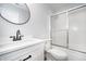 Bright bathroom featuring white vanity with black hardware, a round mirror, and a shower with sliding glass doors at 1008 Canary Creek Ct, Franklin, IN 46131