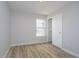 Empty bedroom with wood-look flooring, a window providing natural light, and a closet for ample storage at 1008 Canary Creek Ct, Franklin, IN 46131