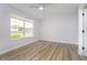 Bright bedroom featuring a large window, neutral walls, and wood-look laminate flooring at 1008 Canary Creek Ct, Franklin, IN 46131