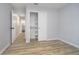 Bedroom showcasing wood-look flooring and a doorway leading to an adjoining bathroom at 1008 Canary Creek Ct, Franklin, IN 46131