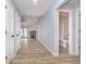 Hallway view showcasing updated flooring, bathroom access and entry to the living room with fireplace at 1008 Canary Creek Ct, Franklin, IN 46131
