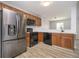 Bright kitchen boasts stainless steel refrigerator, ample wood cabinetry, and modern appliances at 1008 Canary Creek Ct, Franklin, IN 46131
