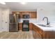 Modern kitchen featuring stainless steel appliances, white countertops, and dark wood cabinets at 1008 Canary Creek Ct, Franklin, IN 46131