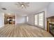 Spacious living room featuring a fireplace, fan, and access to kitchen with stainless steel appliances at 1008 Canary Creek Ct, Franklin, IN 46131