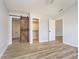Open main bedroom featuring wood-look floors, ensuite bath, and large closet at 1008 Canary Creek Ct, Franklin, IN 46131