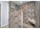 Walk-in shower featuring decorative tile, bench, glass door, and modern fixtures at 1008 Canary Creek Ct, Franklin, IN 46131