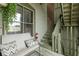 Balcony seating area with adjacent stairs and exposed brick at 108 E Saint Clair St # E, Indianapolis, IN 46204