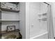 Clean bathroom space featuring tiled walls, and shower storage racks at 108 E Saint Clair St # E, Indianapolis, IN 46204