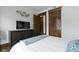 Neat bedroom with a dresser, a TV, and an open doorway revealing another room at 108 E Saint Clair St # E, Indianapolis, IN 46204