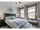Comfortable bedroom with a ceiling fan, large windows, and contemporary furnishings at 108 E Saint Clair St # E, Indianapolis, IN 46204
