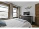 Bright bedroom with large windows, modern dresser, and a decorative wall piece at 108 E Saint Clair St # E, Indianapolis, IN 46204