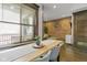 Bright dining area with large window and hardwood floors, next to living room space at 108 E Saint Clair St # E, Indianapolis, IN 46204