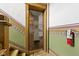 Entryway with detailed trim, staircase, and 'hello' welcome mat at 108 E Saint Clair St # E, Indianapolis, IN 46204