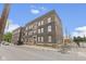 Side view of the building revealing its brick facade, windows, and architectural character at 108 E Saint Clair St # E, Indianapolis, IN 46204