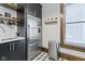 Modern kitchen featuring stainless steel appliances, open shelving, and black and white tile floor at 108 E Saint Clair St # E, Indianapolis, IN 46204