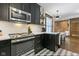 Charming kitchen features modern appliances, black cabinets, and geometric tile flooring at 108 E Saint Clair St # E, Indianapolis, IN 46204