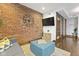 Living room with exposed brick, modern decor and hardwood floors at 108 E Saint Clair St # E, Indianapolis, IN 46204