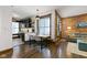 Open-concept living space featuring kitchen and dining area near brick accent wall at 108 E Saint Clair St # E, Indianapolis, IN 46204