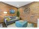 Living room with exposed brick, stylish furniture, and modern decor at 108 E Saint Clair St # E, Indianapolis, IN 46204