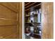 Spacious pantry featuring well-organized wooden shelving, providing ample storage space at 108 E Saint Clair St # E, Indianapolis, IN 46204