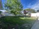 Spacious backyard with a hammock, mature trees, and plenty of room for outdoor activities at 1122 Shelby St, Shelbyville, IN 46176