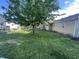 Lush backyard with mature trees, a hammock, and a detached garage for added convenience at 1122 Shelby St, Shelbyville, IN 46176
