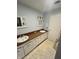 Bright bathroom featuring double sinks with vanity, and a framed mirror at 1122 Shelby St, Shelbyville, IN 46176