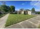 Well-manicured lawn surrounds this home with a detached three-car garage and ample parking at 1122 Shelby St, Shelbyville, IN 46176