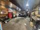 Spacious garage featuring ATV, workbench, tools, and ample storage space for hobbies or projects at 1122 Shelby St, Shelbyville, IN 46176