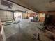 Image shows large garage with multiple doors with tools and various garage items scattered about at 1122 Shelby St, Shelbyville, IN 46176