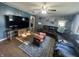 Cozy living room featuring hardwood floors, a sectional sofa, and a large flat-screen television at 1122 Shelby St, Shelbyville, IN 46176