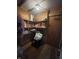 Image shows storage room with shelving, a chair, a bag, and various items on shelves at 1122 Shelby St, Shelbyville, IN 46176