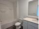Well-lit bathroom with a shower-tub combo, modern vanity, and vinyl plank flooring at 11302 N Quillow Way, Monrovia, IN 46157