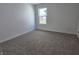 Cozy bedroom with neutral walls, plush carpeting, and a window offering natural light at 11302 N Quillow Way, Monrovia, IN 46157