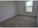 Comfortable bedroom featuring neutral walls, plush carpeting, and a bright window at 11302 N Quillow Way, Monrovia, IN 46157