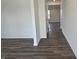 Hallway featuring luxury vinyl plank flooring, white trim, and access to multiple rooms at 11302 N Quillow Way, Monrovia, IN 46157