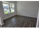 Well-lit living room featuring luxury vinyl plank flooring and white walls at 11302 N Quillow Way, Monrovia, IN 46157