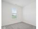Minimalist bedroom with plush gray carpet and natural light at 11469 Lottie Cir, Noblesville, IN 46060