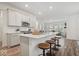 Modern kitchen with quartz countertops, stainless steel appliances, and island seating at 11469 Lottie Cir, Noblesville, IN 46060