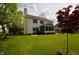 Spacious backyard featuring a well-maintained lawn and a screened porch for outdoor relaxation at 11850 Stepping Stone Dr, Fishers, IN 46037