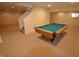 Finished basement with carpet flooring and a billiard table at 11850 Stepping Stone Dr, Fishers, IN 46037