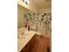 Well-lit bathroom features a vanity with sink, toilet, and a decorative shower curtain at 11850 Stepping Stone Dr, Fishers, IN 46037
