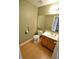 Bathroom with vinyl floors, a wooden cabinet sink, and a large mirror at 11850 Stepping Stone Dr, Fishers, IN 46037