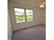 Bright bedroom features neutral carpet, ceiling fan, and large window with pond view at 11850 Stepping Stone Dr, Fishers, IN 46037